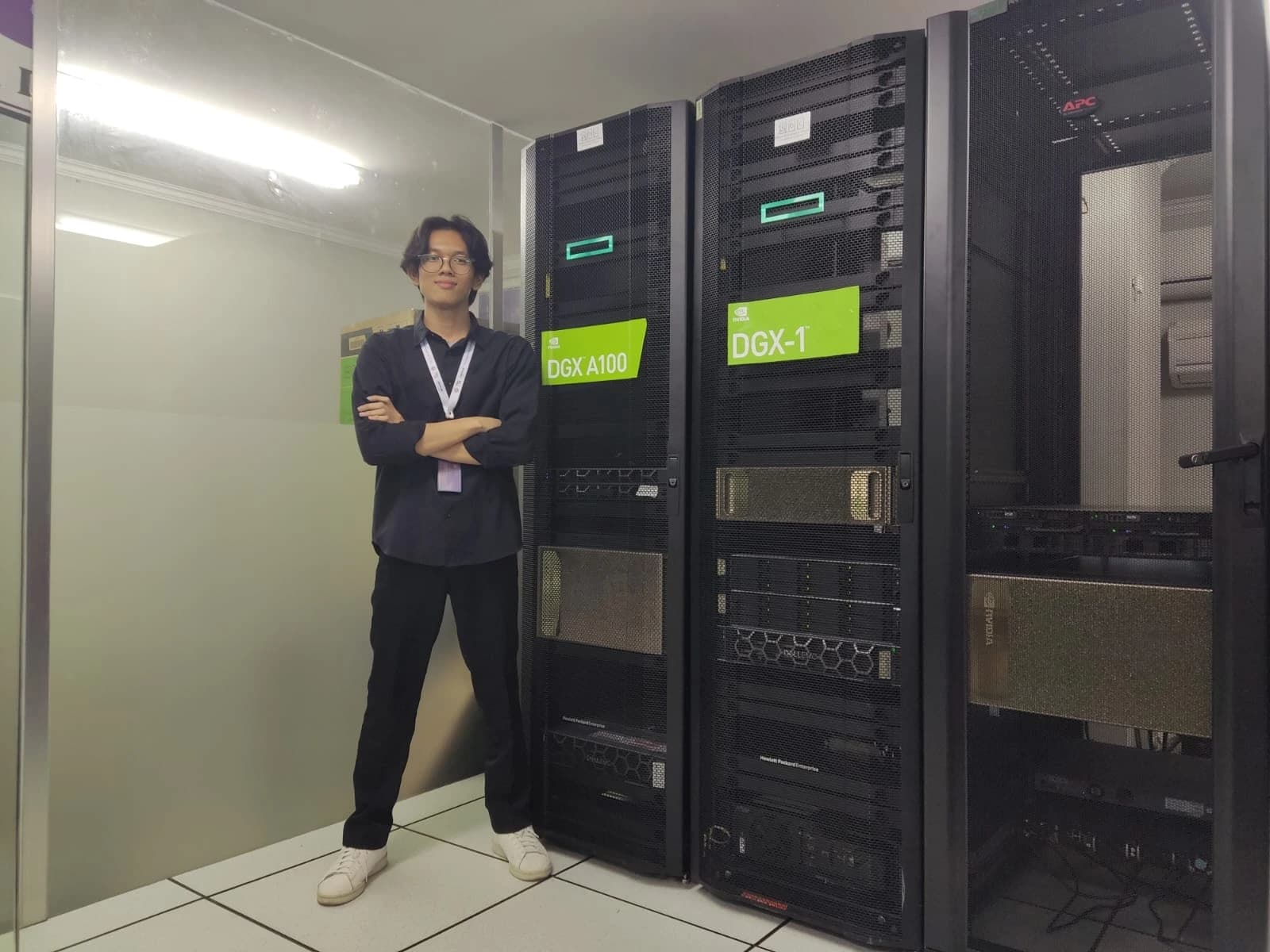 Felix standing beside an NVIDIA DGX A100 system